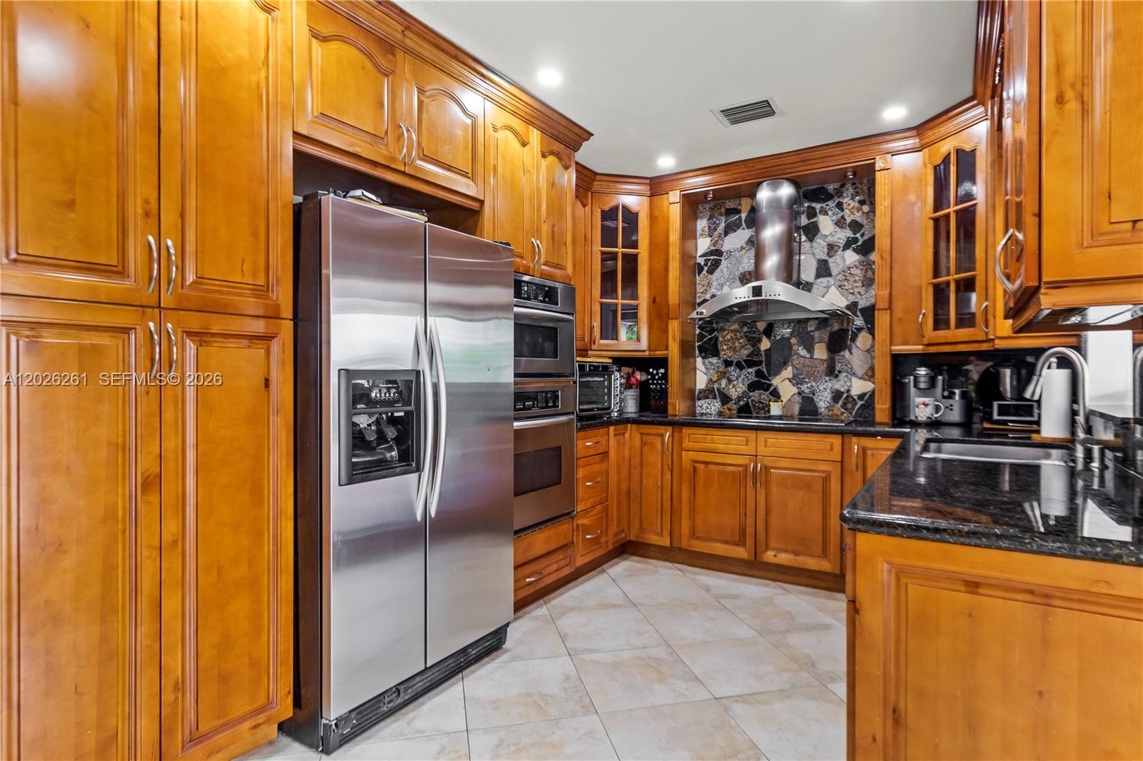 6250 Southwest 20th Terrace Miami, FL 33155 - Photo 8 of 42 a kitchen with stainless steel appliances granite countertop a refrigerator and a sink