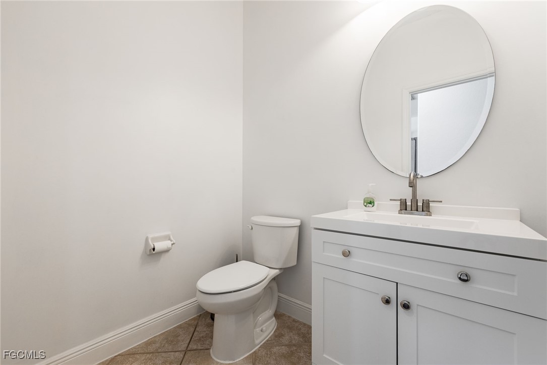 12406 Rock Ridge Lane Fort Myers, FL 33913 - Photo 15 of 35 a bathroom with a toilet a sink and mirror