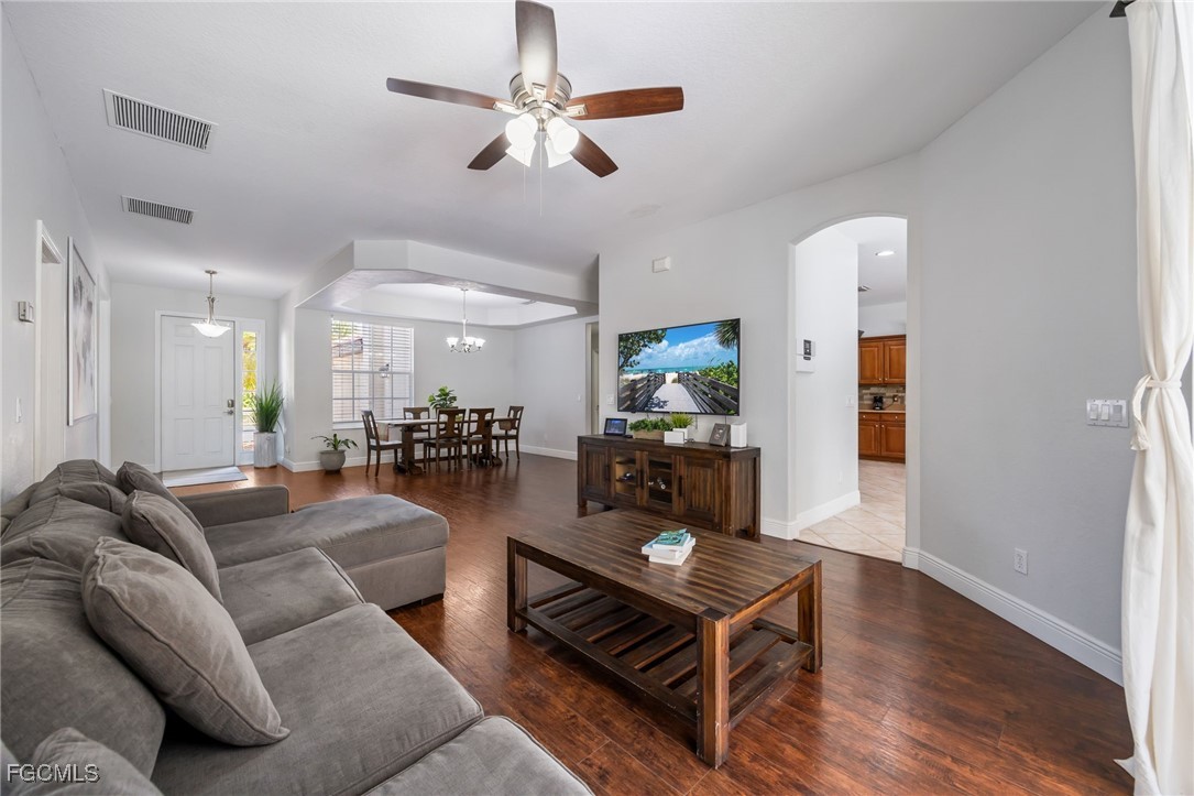 12406 Rock Ridge Lane Fort Myers, FL 33913 - Photo 6 of 35 a living room with furniture kitchen view and a wooden floor