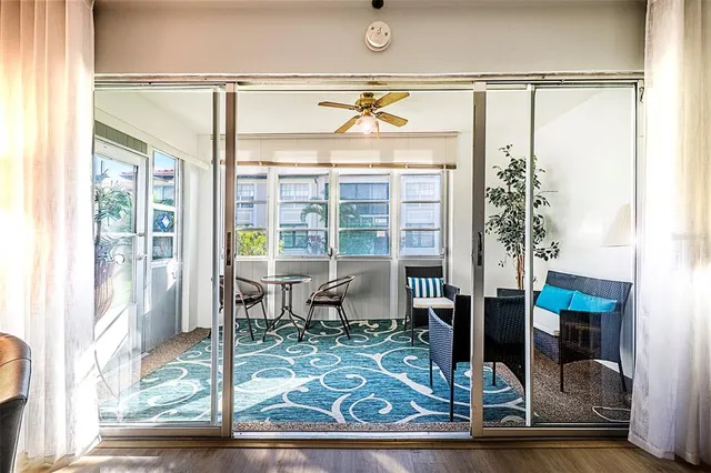 a view of living room with a floor to ceiling window and wooden floor