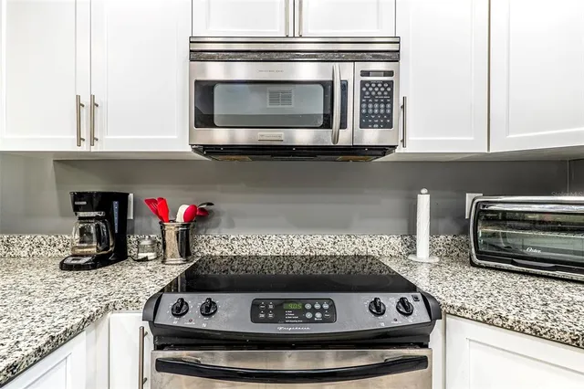 a stove top oven sitting inside of a kitchen