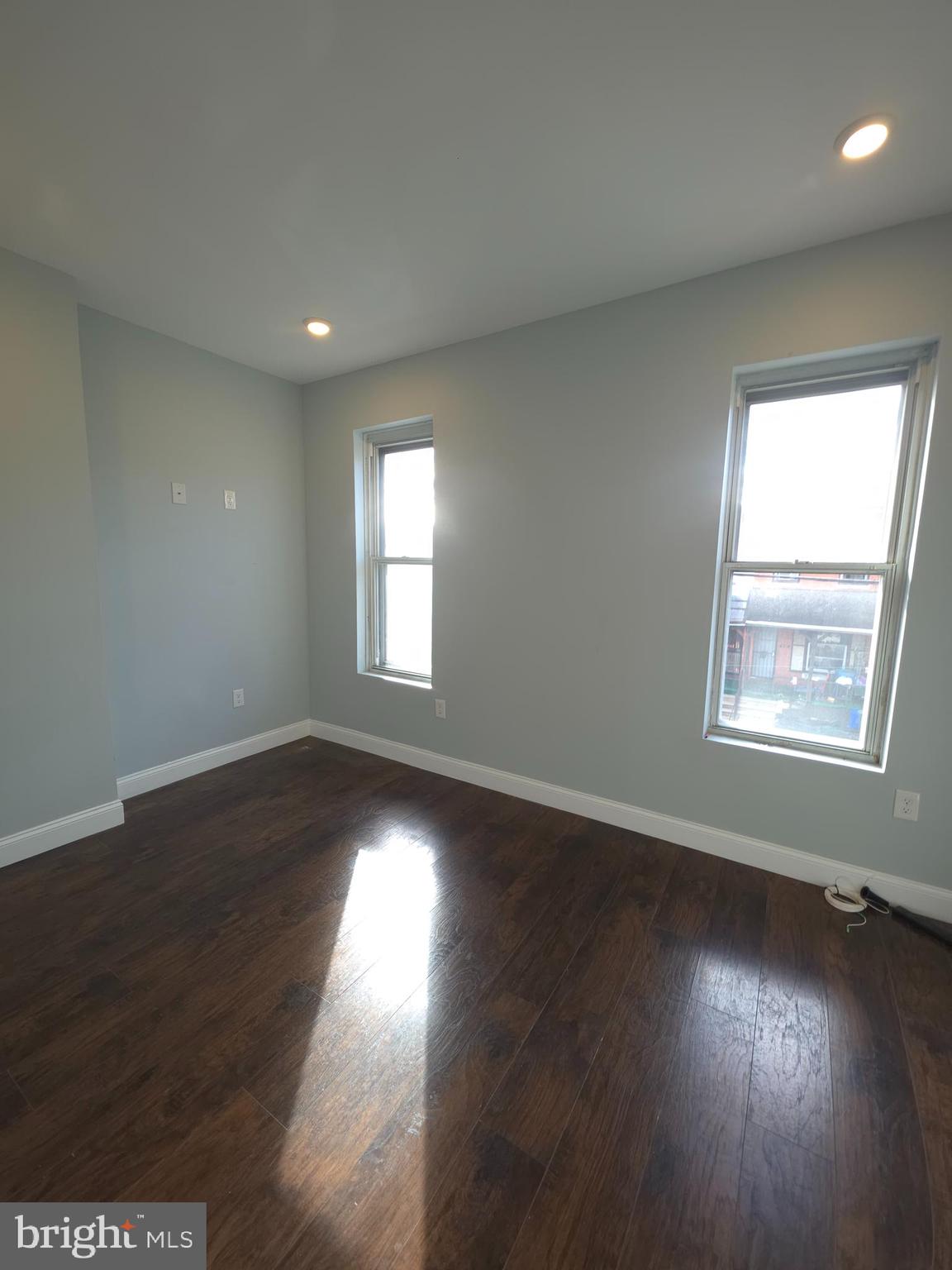 1135 West Somerset Street, Unit 2 Philadelphia, PA 19133 - Photo 11 of 15 an empty room with wooden floor and windows