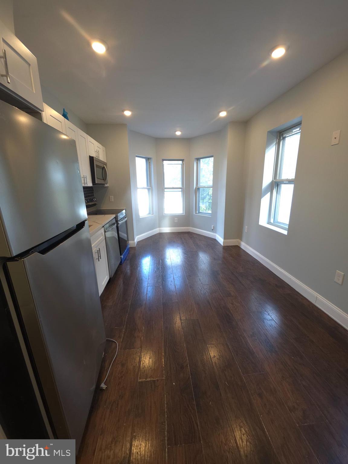 1135 West Somerset Street, Unit 2 Philadelphia, PA 19133 - Photo 3 of 15 a view of livingroom with kitchen and wooden floor