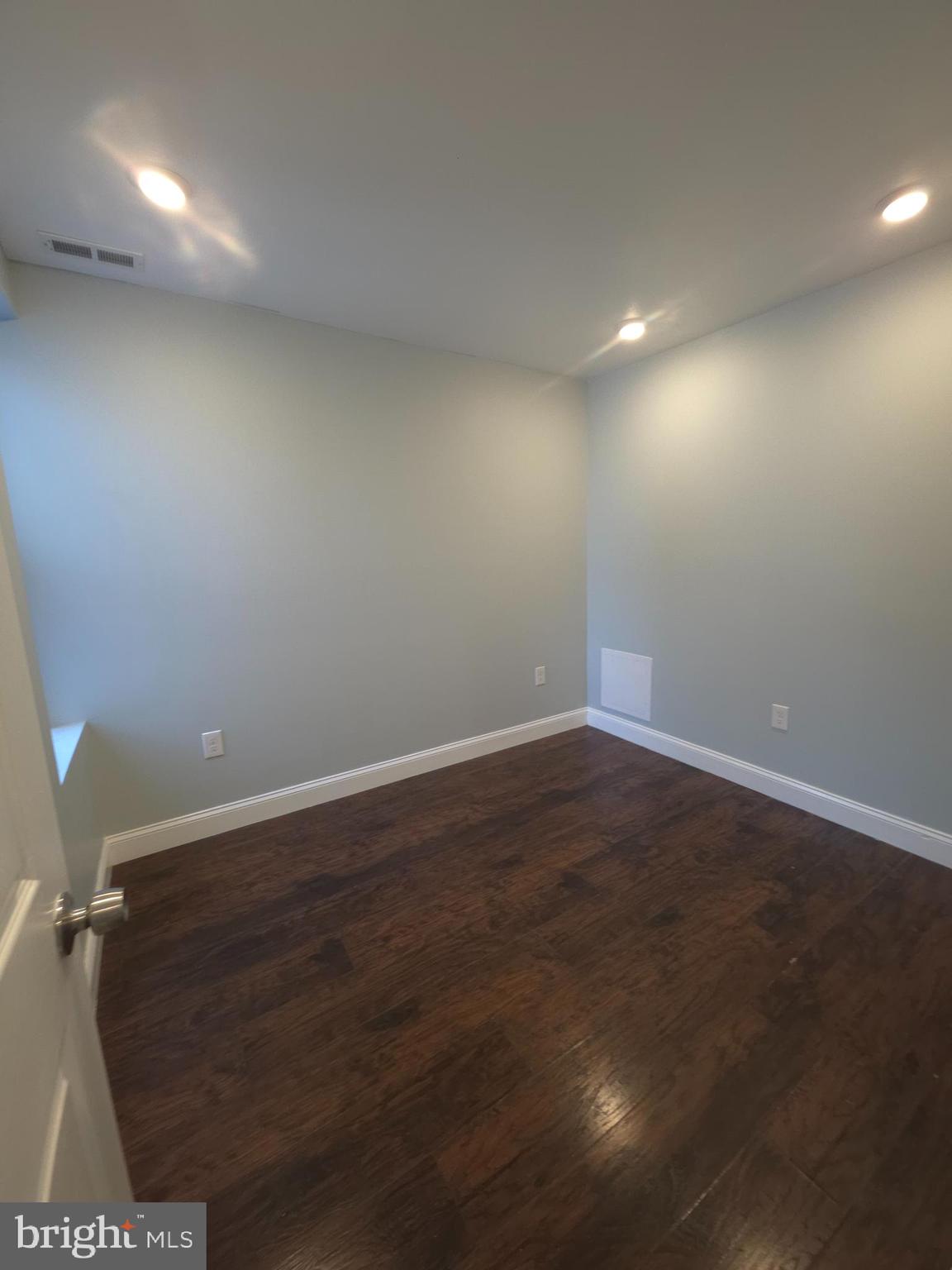 1135 West Somerset Street, Unit 2 Philadelphia, PA 19133 - Photo 7 of 15 an empty room with wooden floor and windows