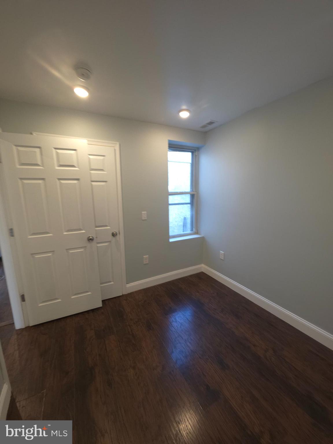 1135 West Somerset Street, Unit 2 Philadelphia, PA 19133 - Photo 8 of 15 an empty room with wooden floor and windows