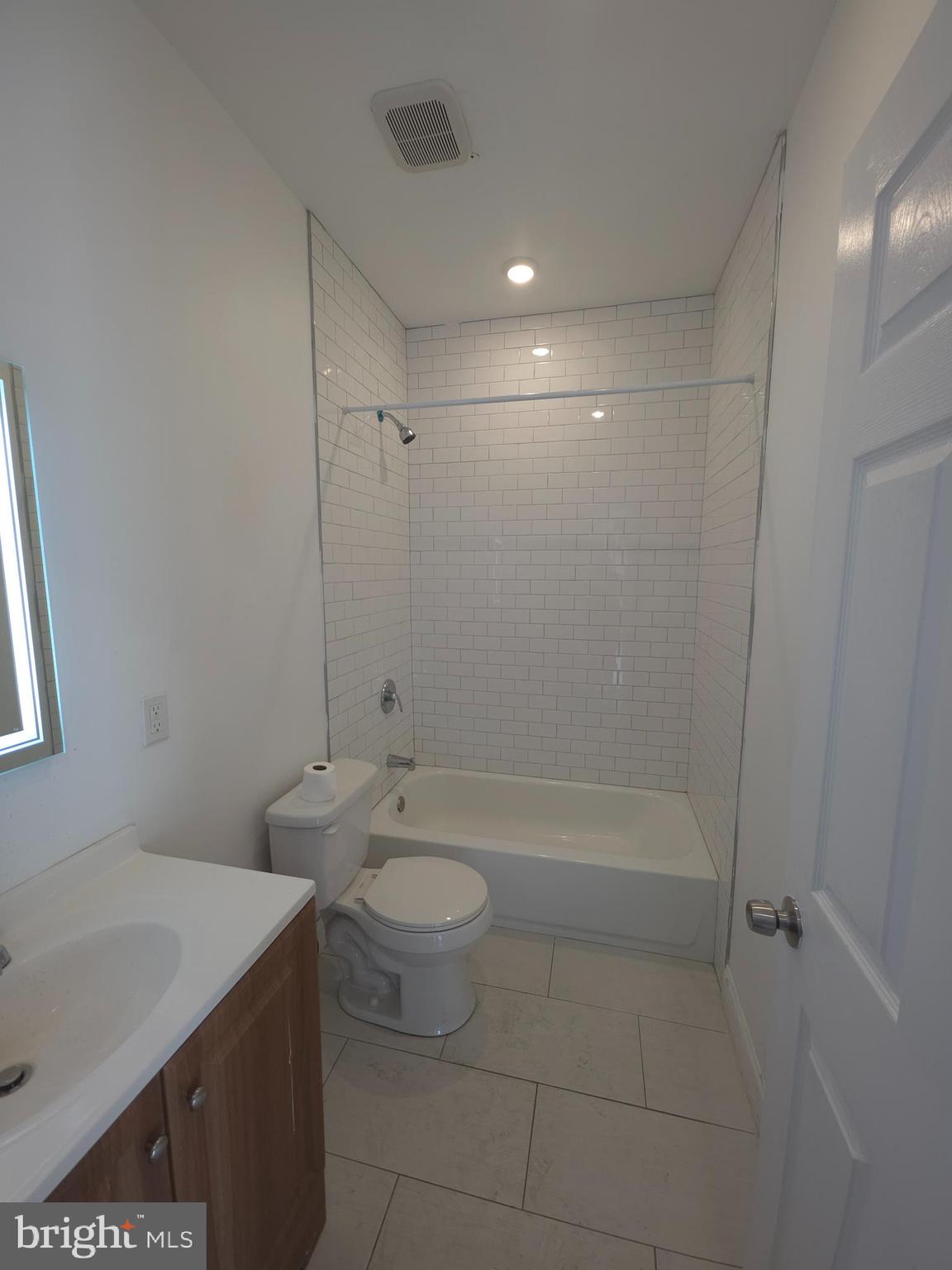 1135 West Somerset Street, Unit 2 Philadelphia, PA 19133 - Photo 9 of 15 a bathroom with a bathtub shower sink vanity and toilet