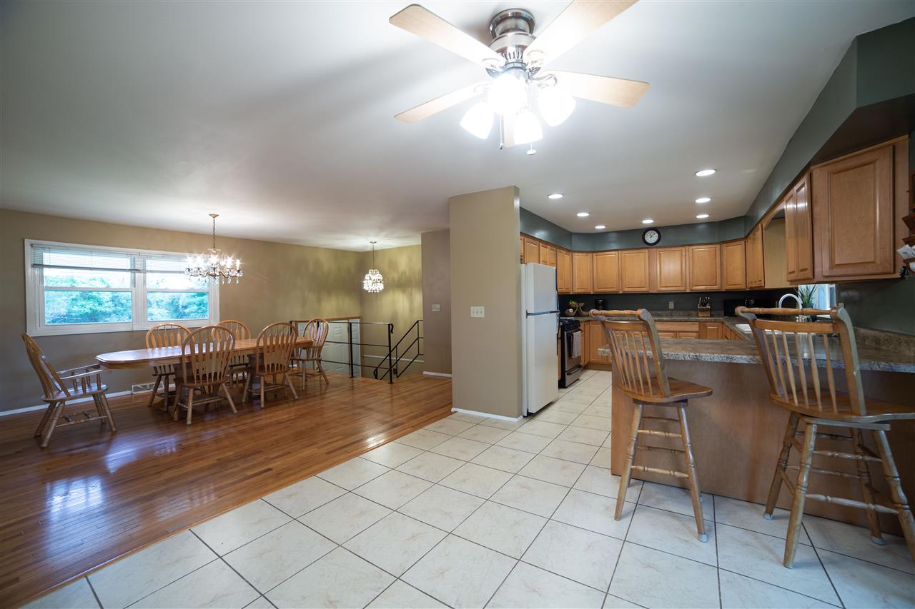 6601 Halley Road Rockford, IL 61101 - Photo 6 of 40 a open kitchen with stainless steel appliances kitchen island granite countertop a table chairs and a refrigerator