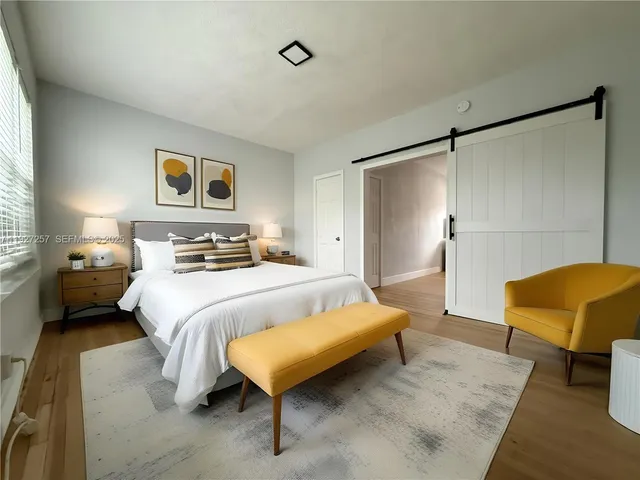 a bedroom with a bed and a lamp with window