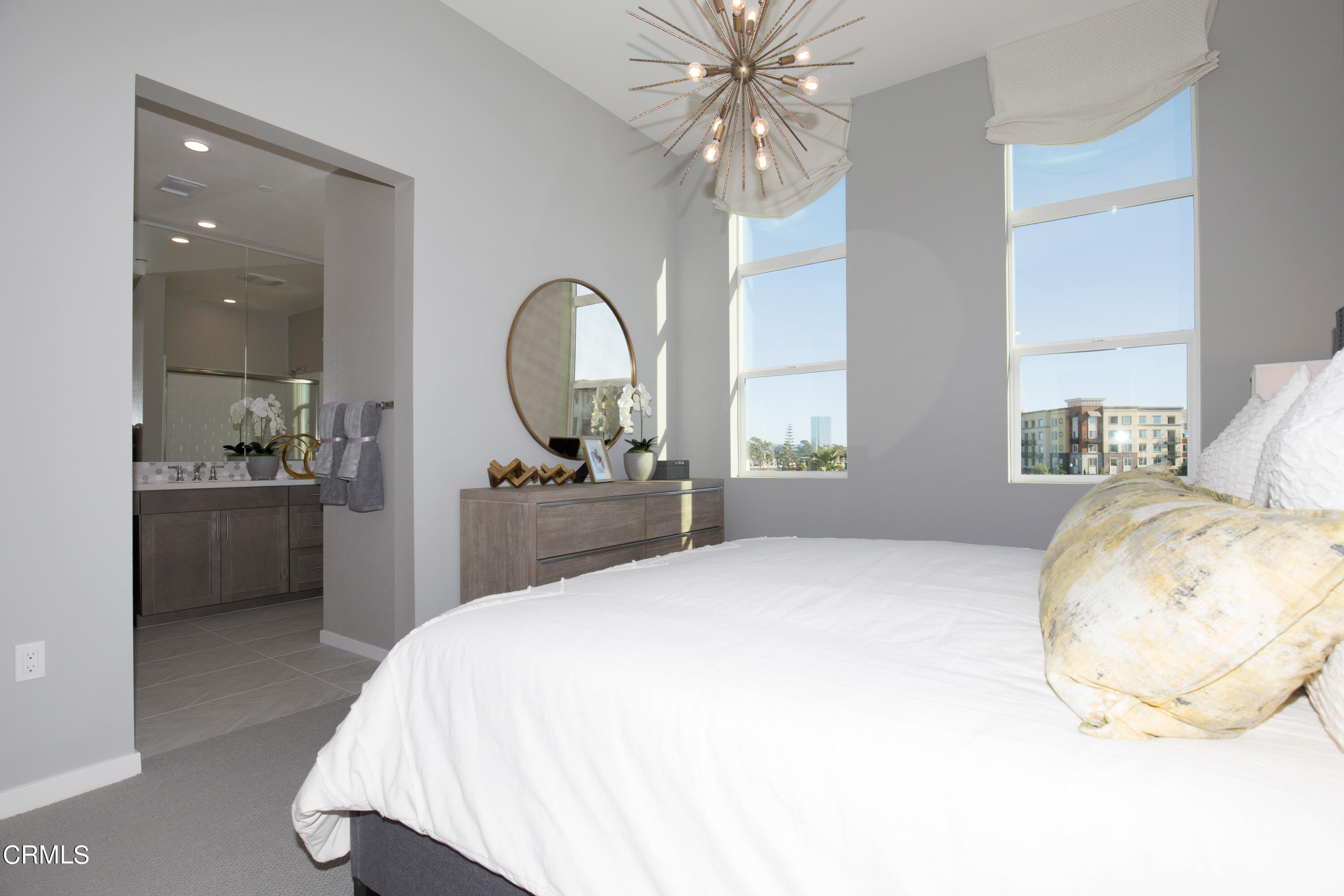 703 Winchester Drive Oxnard, CA 93036 - Photo 12 of 30 a bedroom with a large bed and a chandelier