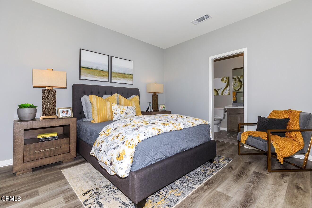 703 Winchester Drive Oxnard, CA 93036 - Photo 14 of 30 a bedroom with a bed and wooden floor