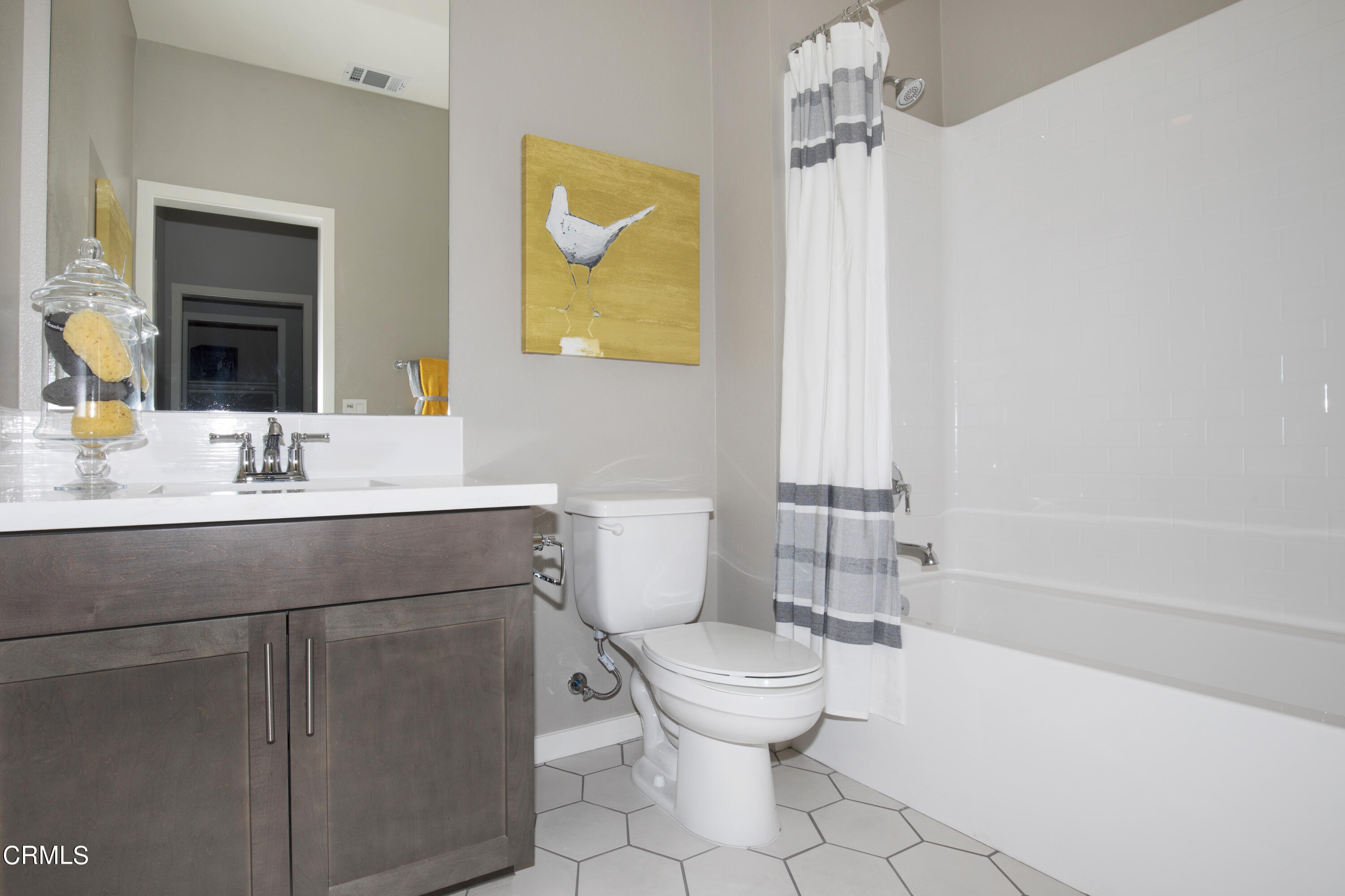 703 Winchester Drive Oxnard, CA 93036 - Photo 22 of 30 a bathroom with a sink mirror vanity and toilet