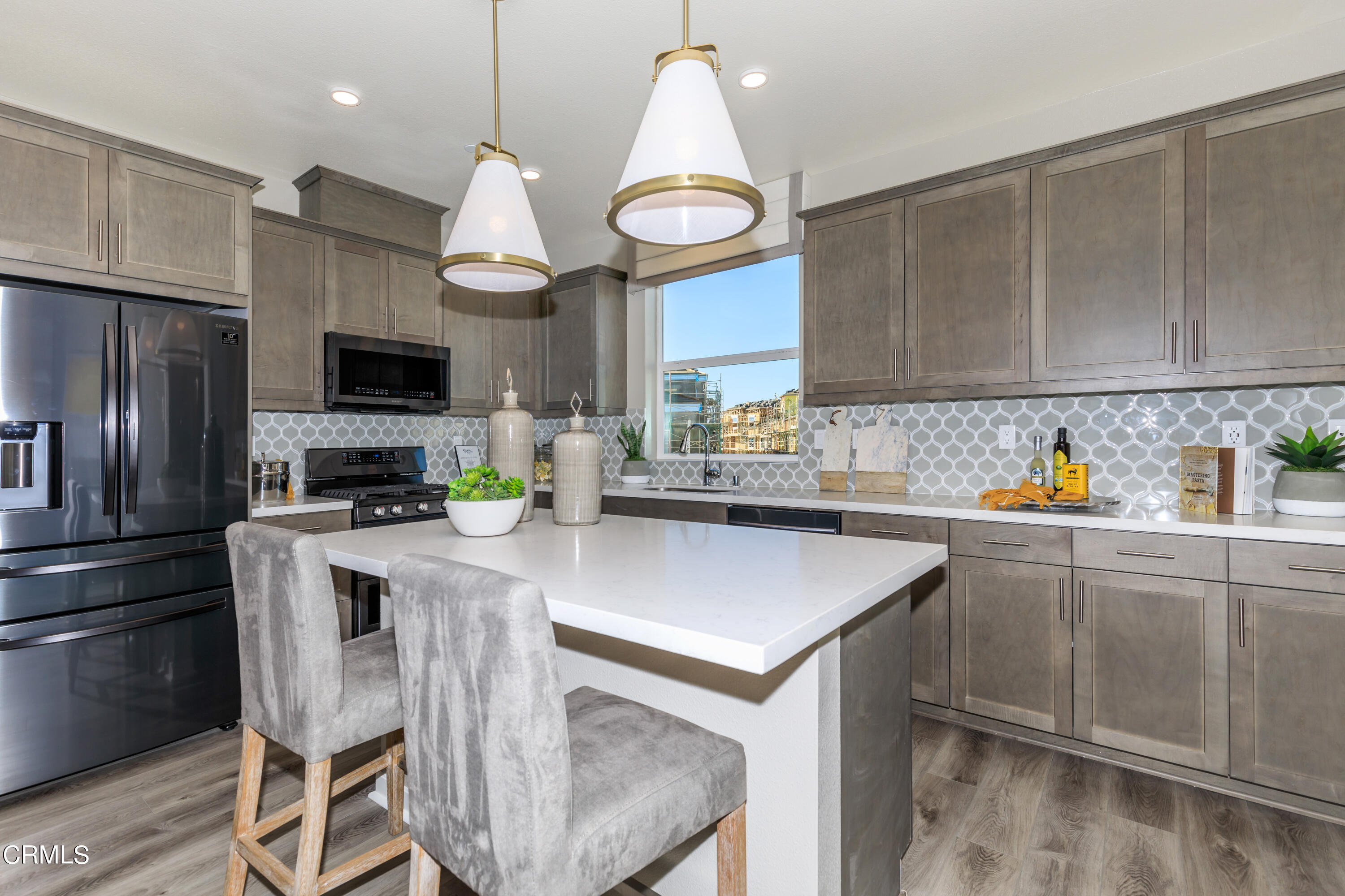 703 Winchester Drive Oxnard, CA 93036 - Photo 4 of 30 a kitchen with cabinets a center island stainless steel appliances and cabinets