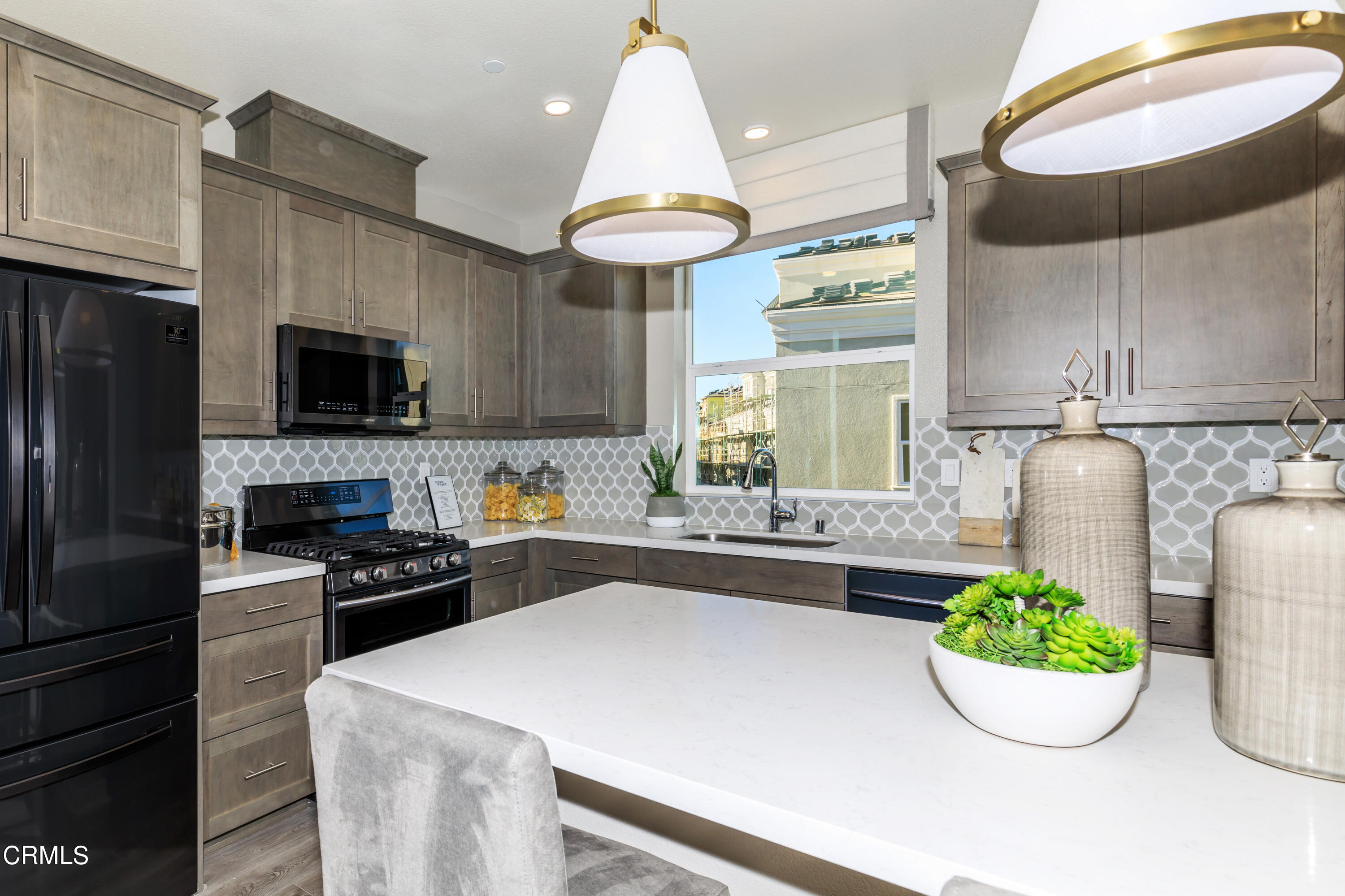 703 Winchester Drive Oxnard, CA 93036 - Photo 5 of 30 a kitchen with a stove a microwave and cabinets