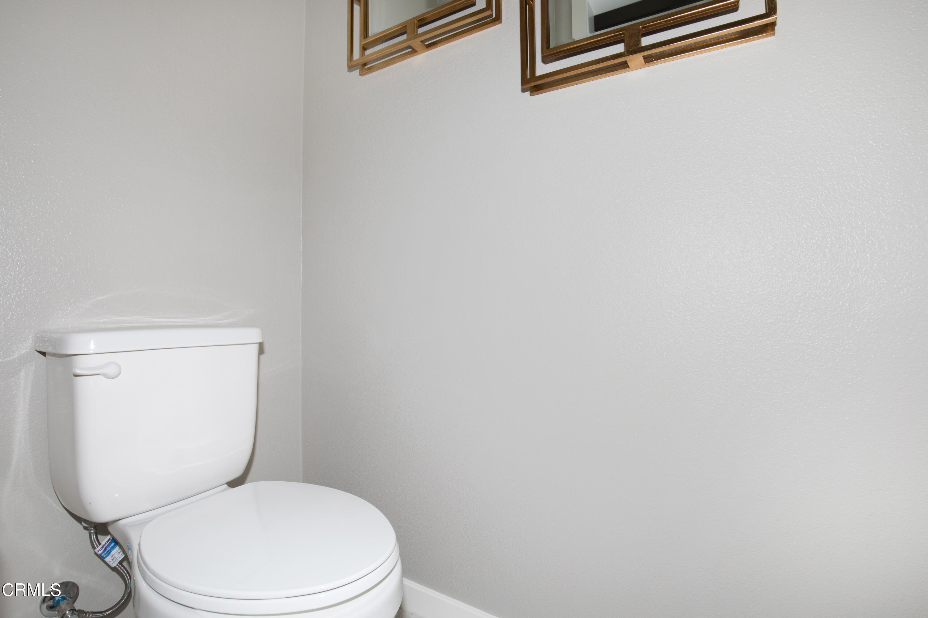 703 Winchester Drive Oxnard, CA 93036 - Photo 10 of 30 a white toilet sitting next to a white wall