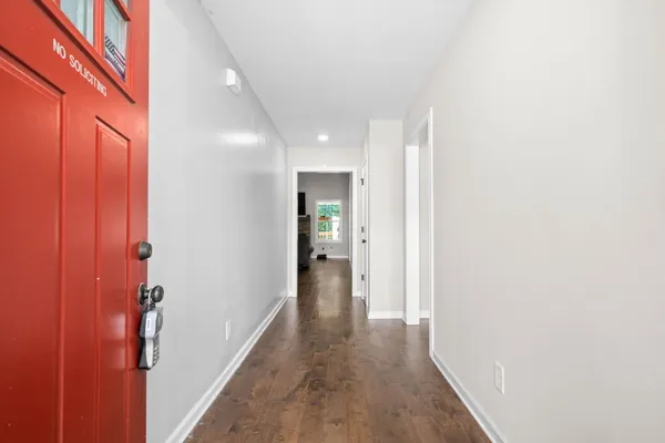 a view of a hallway with wooden floor