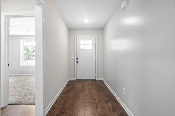 a view of hallway with wooden floor