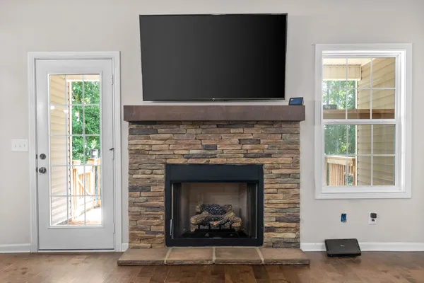 a living room with a fireplace and a flat screen tv