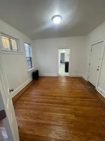 a view of a room with wooden floor and windows