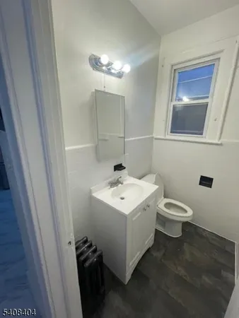 a bathroom with a sink toilet and mirror