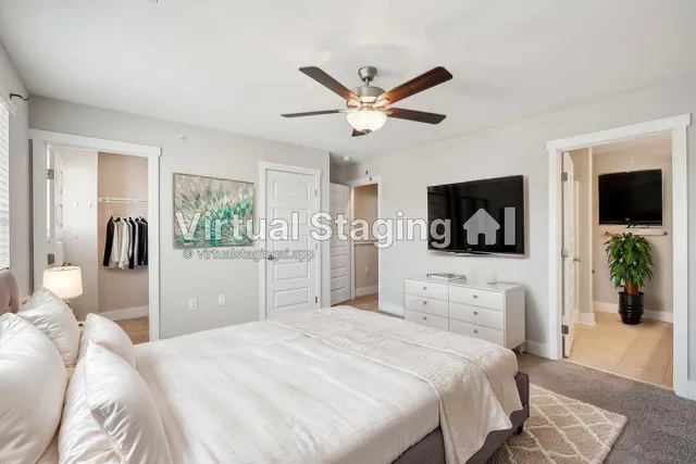 a bedroom with a large bed and a flat screen tv