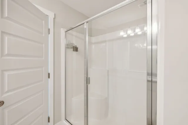 a bathroom with a glass shower door