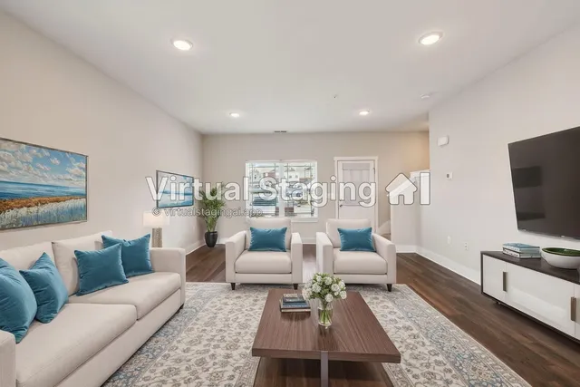 a living room with furniture a rug and a flat screen tv