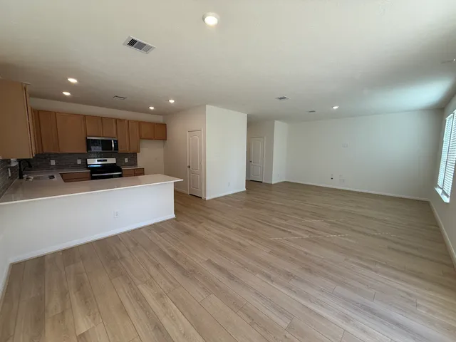 a view of kitchen with microwave and cabinets