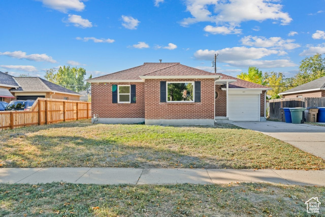 1031 North Rambler Drive Salt Lake City, UT 84116 - Photo 1 of 1 Single story home featuring concrete driveway, brick siding, roof with shingles, and a garage
