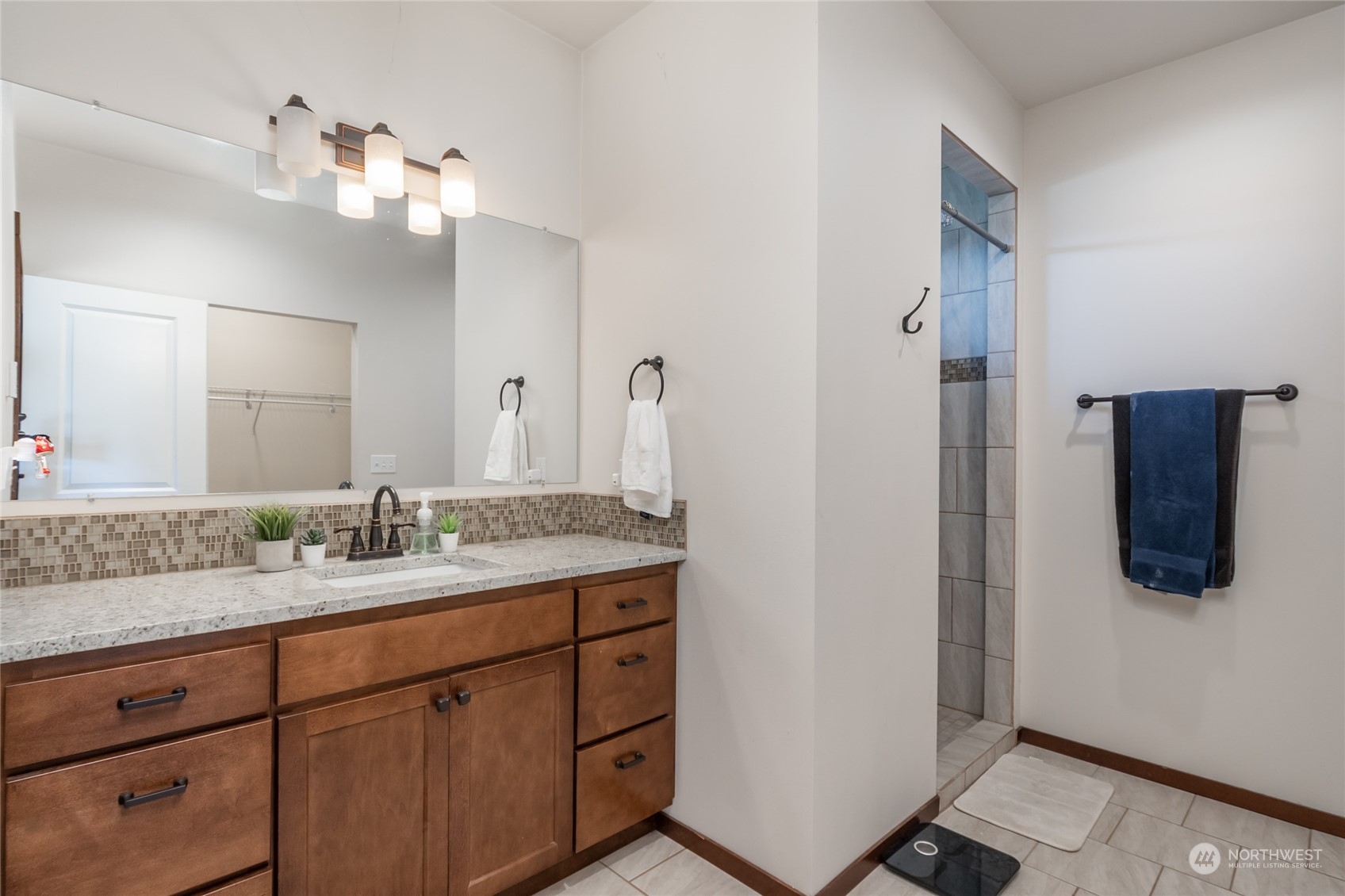 11 West Green Valley Road Oak Harbor, WA 98277 - Photo 14 of 36 a bathroom with a granite countertop sink a mirror and shower