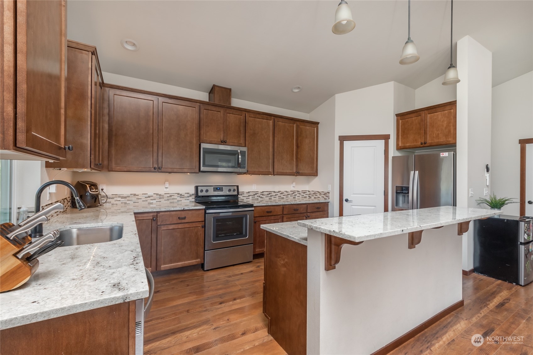 11 West Green Valley Road Oak Harbor, WA 98277 - Photo 6 of 36 a kitchen with stainless steel appliances granite countertop a sink stove and refrigerator