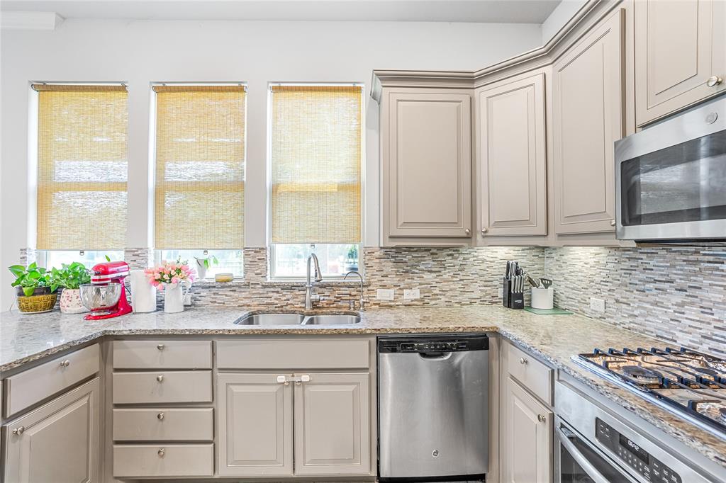 464 Renaissance Lane Irving, TX 75060 - Photo 11 of 31 a kitchen with granite countertop a sink stainless steel appliances and cabinets