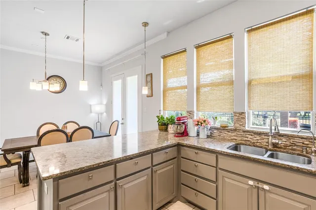 a kitchen with sink a window and white wooden floor