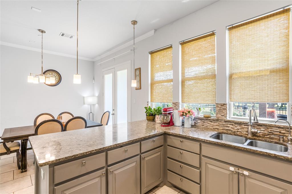 464 Renaissance Lane Irving, TX 75060 - Photo 13 of 31 a kitchen with sink a window and white wooden floor