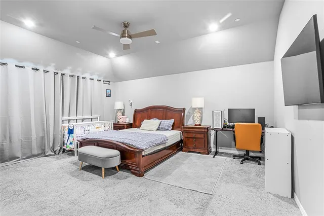 a spacious bedroom with a bed and a table in it