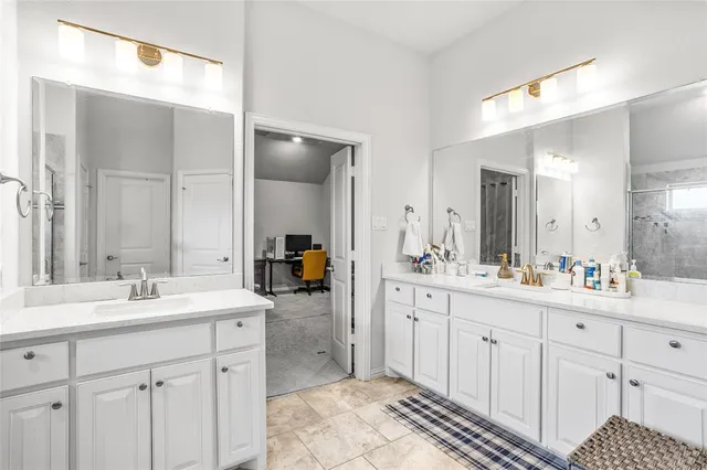 a spacious bathroom with a double vanity sink mirror and