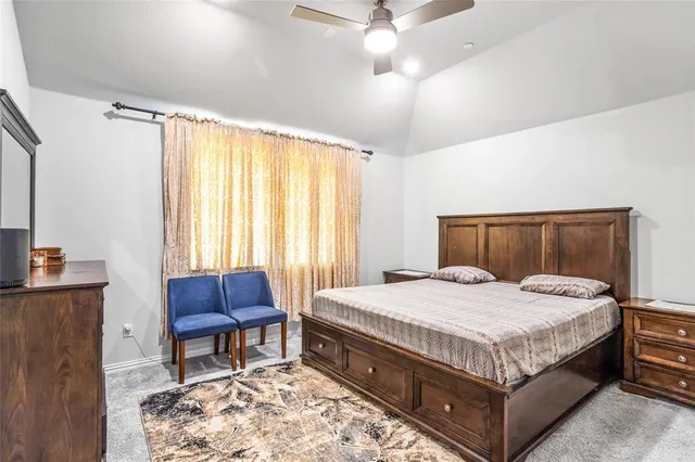 a bedroom with a bed and a chair