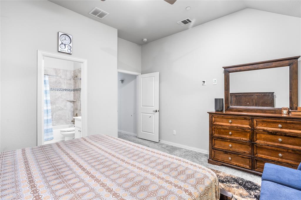 464 Renaissance Lane Irving, TX 75060 - Photo 22 of 31 a bedroom with a bed and a mirror on dresser
