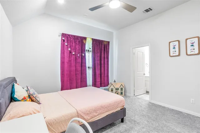 a bed room with a bed and a chair