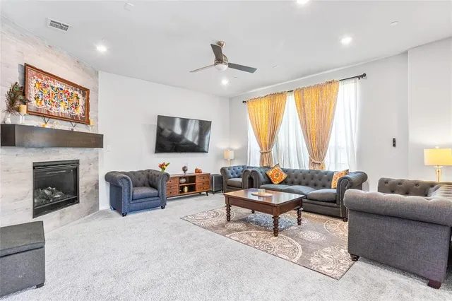 a living room with furniture a large window and a flat screen tv