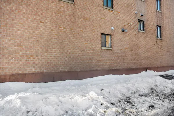 a car parked in front of a brick building
