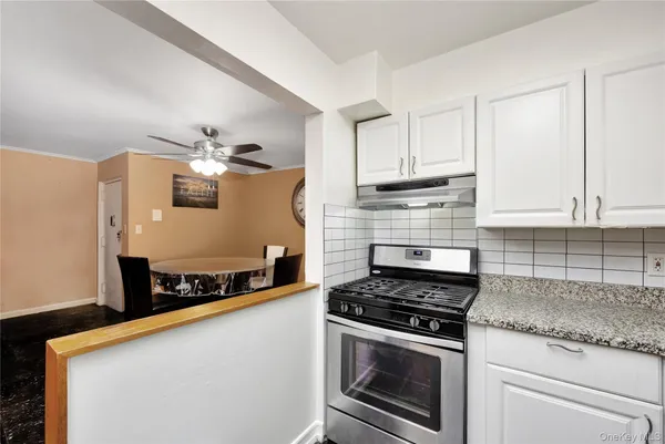 a kitchen with a white cabinets and white appliances