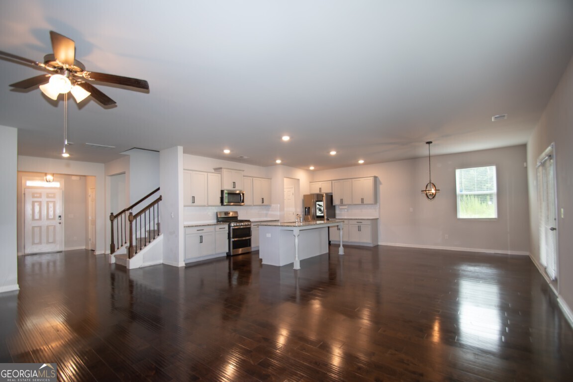 8084 Louis Drive Locust Grove, GA 30248 - Photo 16 of 44 a view of kitchen and dining room with wooden floor