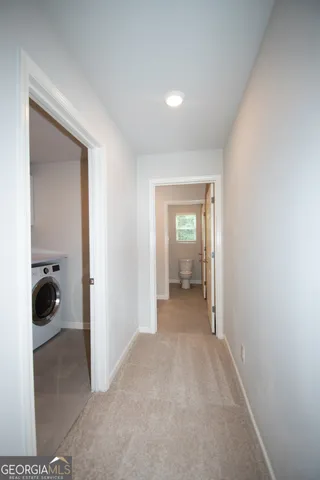 a spacious bathroom with a toilet sink and mirror