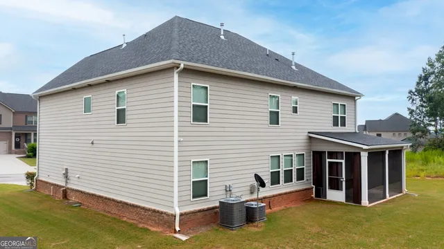 a view of a house with a yard and roof