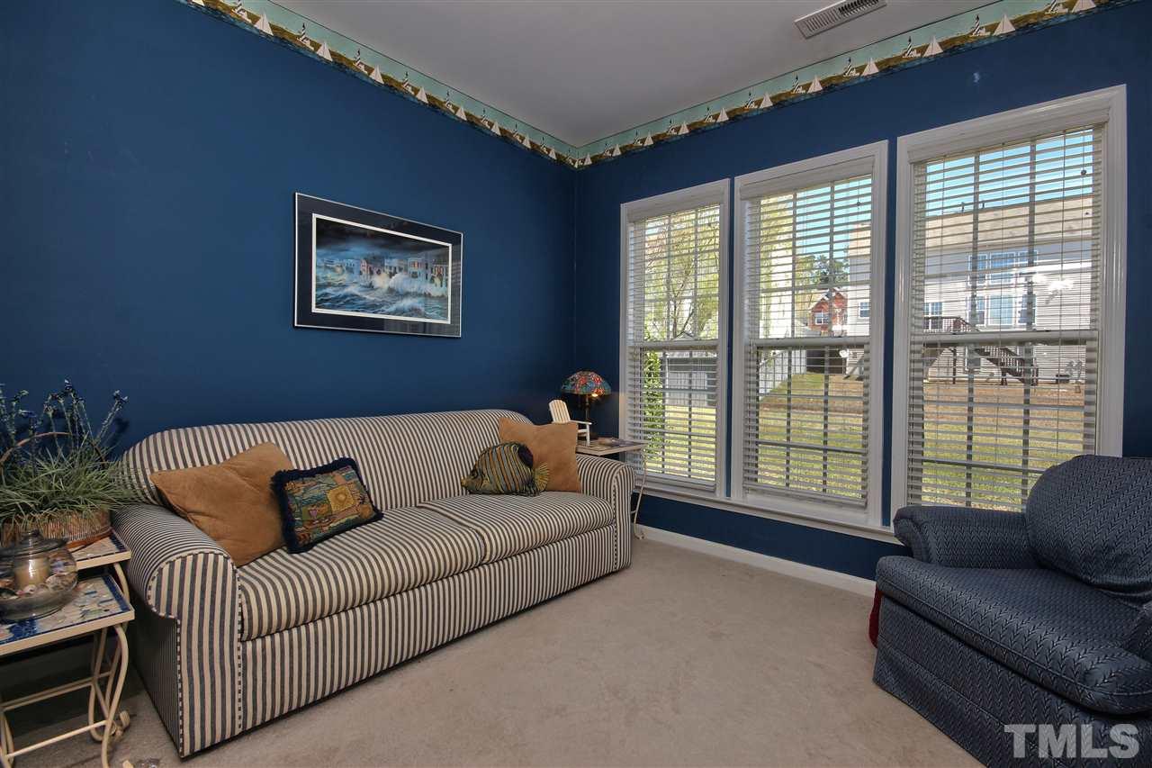 7616 Derek Drive Raleigh, NC 27613 - Photo 11 of 25 a living room with furniture and a large window