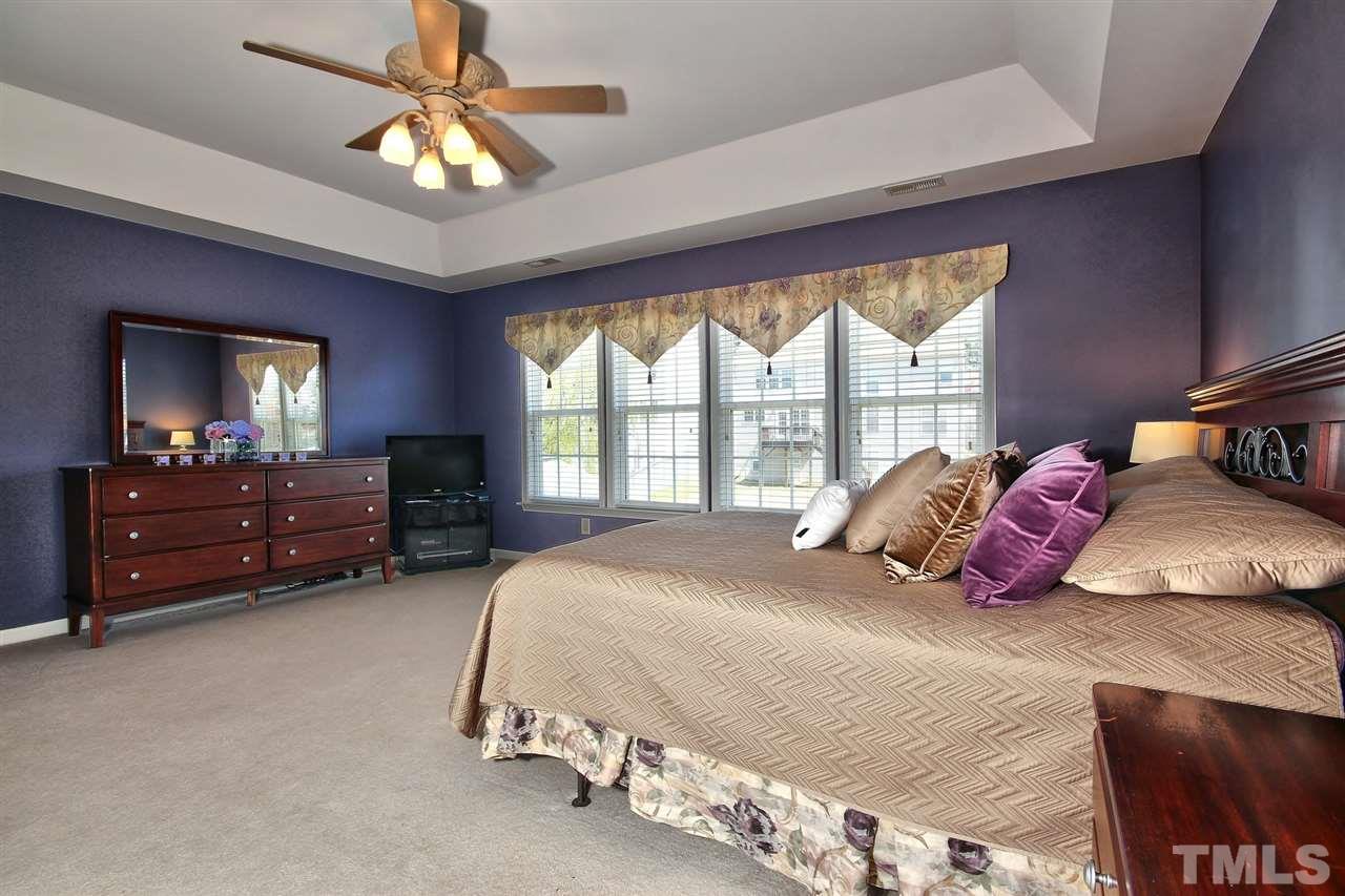 7616 Derek Drive Raleigh, NC 27613 - Photo 14 of 25 a bedroom with a bed dresser and a window