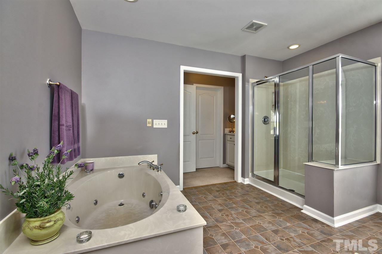 7616 Derek Drive Raleigh, NC 27613 - Photo 16 of 25 a bathroom with a tub and shower