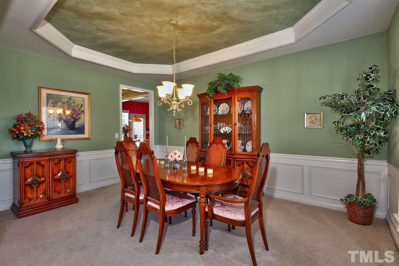 7616 Derek Drive Raleigh, NC 27613 - Photo 4 of 25 a view of a dining room with furniture and chandelier