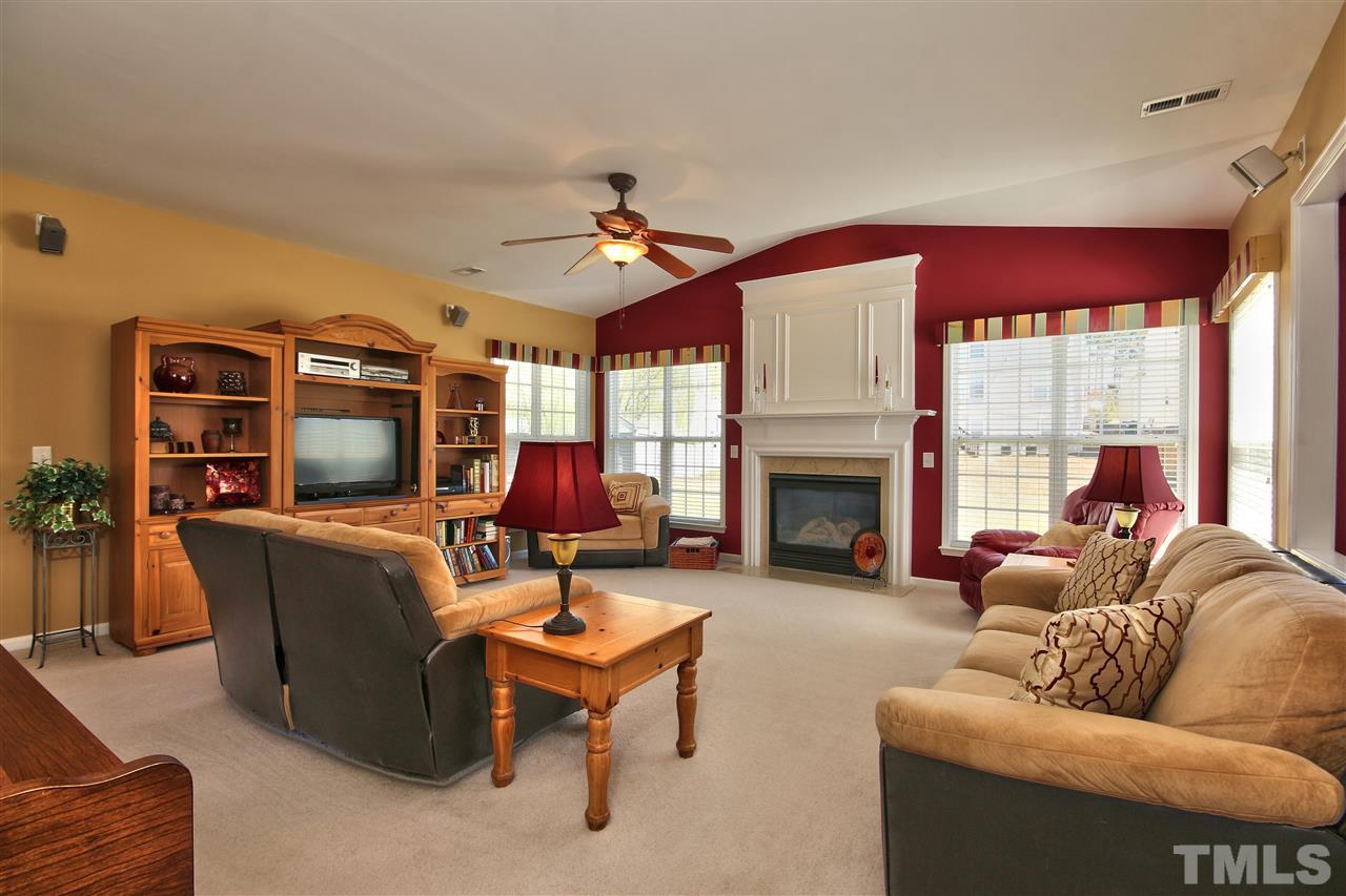 7616 Derek Drive Raleigh, NC 27613 - Photo 6 of 25 a living room with furniture and a fireplace