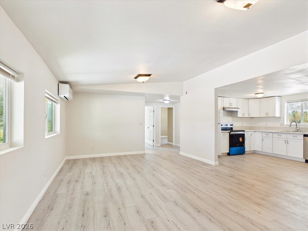 4081 Retread Road Pahrump, NV 89048 - Photo 96 of 98 An open floor plan seamlessly connects the living area to a pristine kitchen, featuring modern appliances and ample natural light.